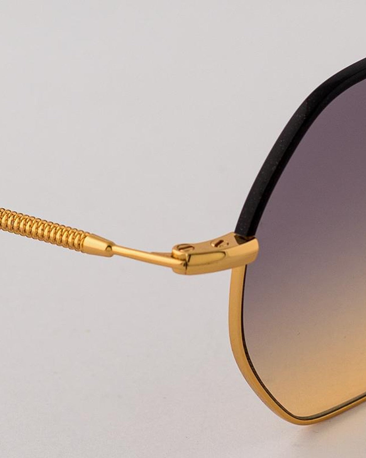 Close-up of the coil-wrapped temple and gold hinge on EYEPETIZER NAMIB C.4-A-19 sunglasses.