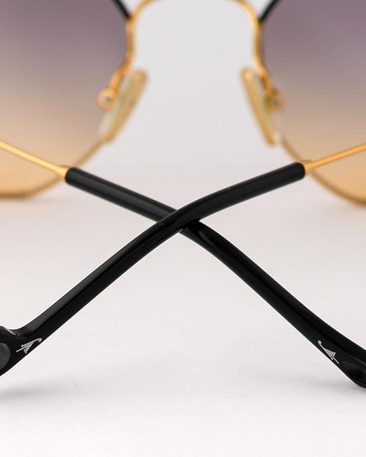 Detail of crossed black temple tips on EYEPETIZER NAMIB C.4-A-19 sunglasses.