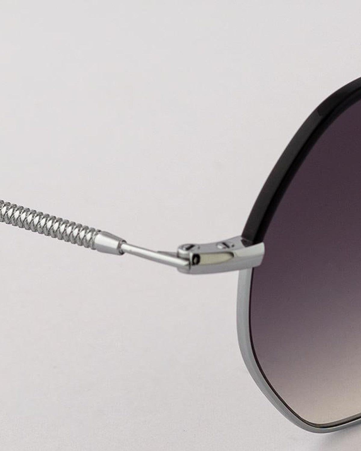 Close-up of the coiled cable temple and hinge on EYEPETIZER NAMIB C.1-A-27 sunglasses.