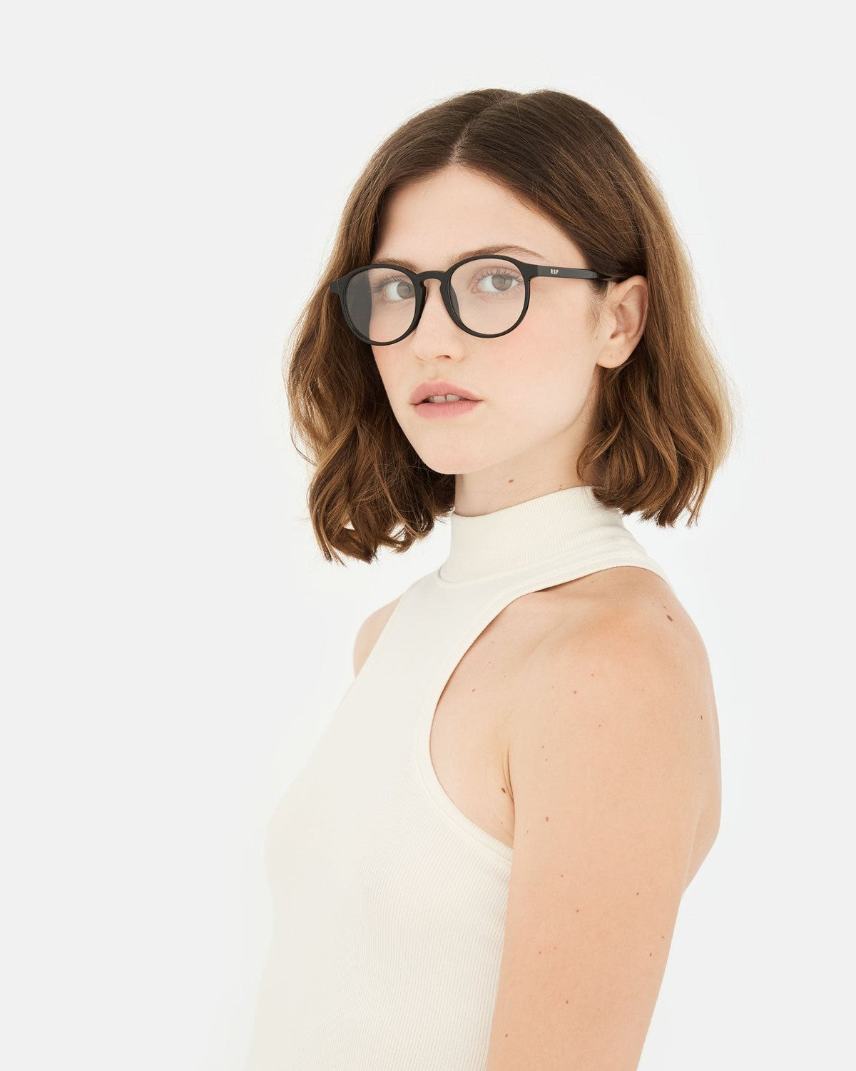 Model wearing RETROSUPERFUTURE Numero 01 Black sunglasses in a three-quarter profile.