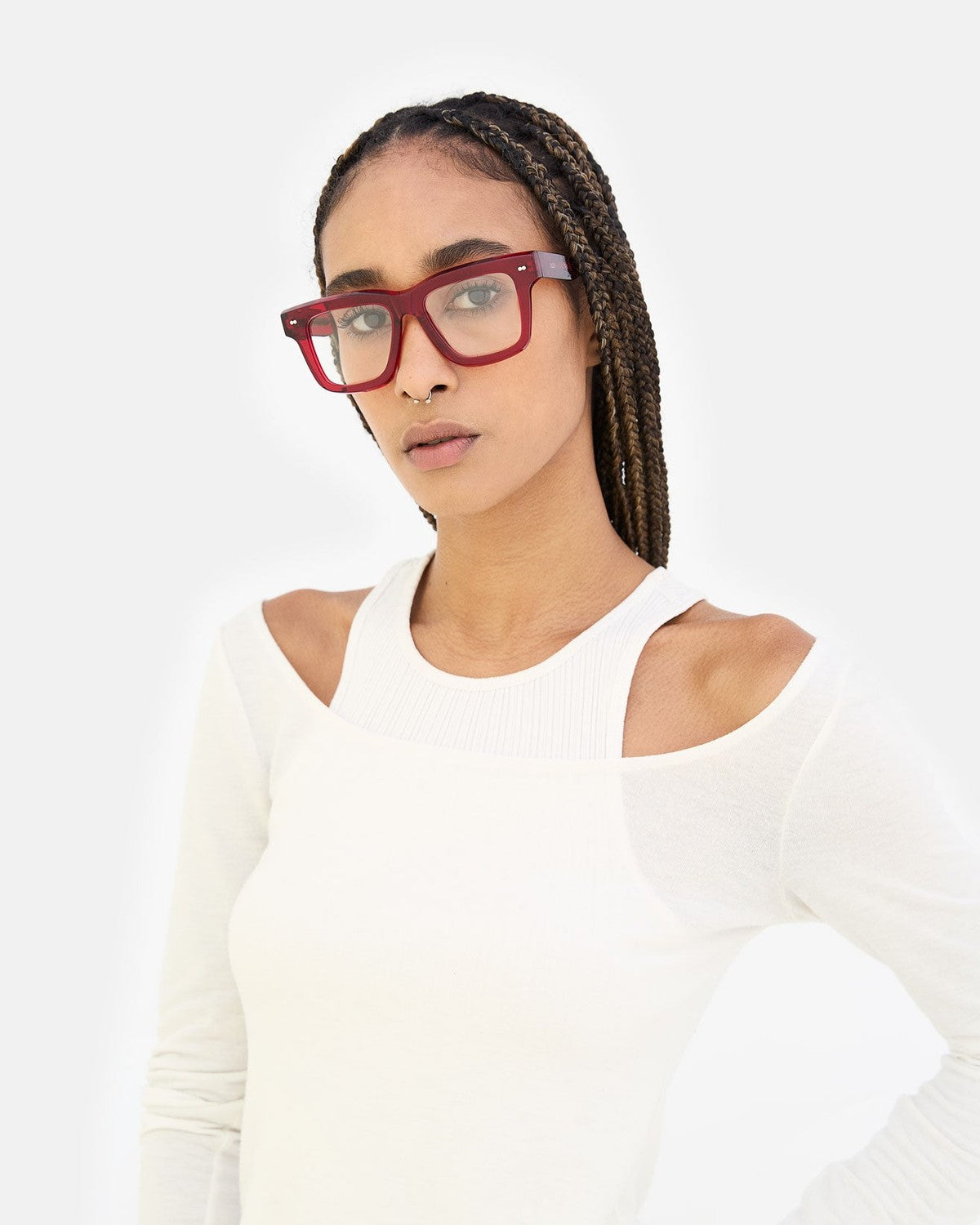 Model wearing RETROSUPERFUTURE Numero 116 Mattone sunglasses with braided hair and white cut-out top.