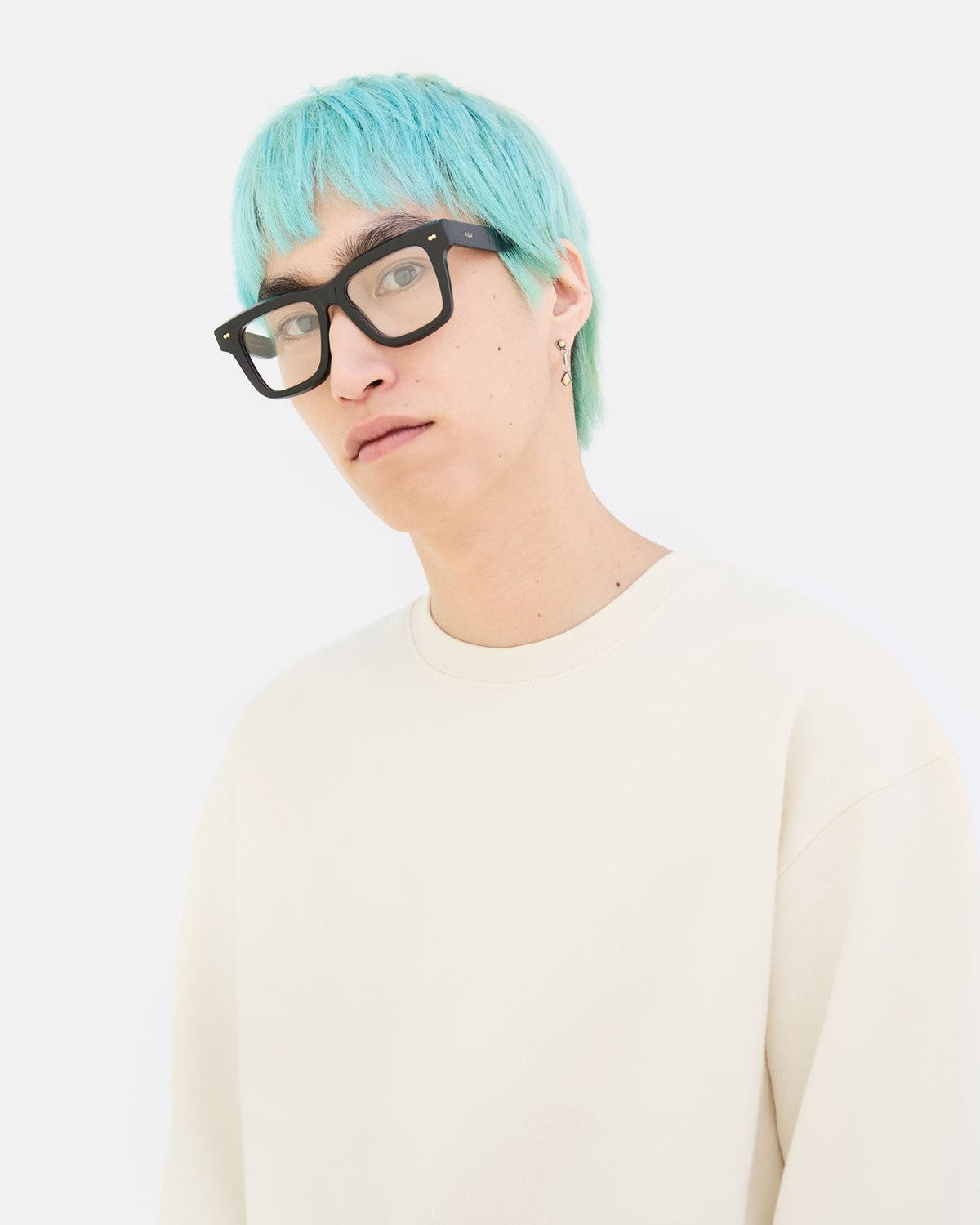 Model in white sweatshirt wearing RETROSUPERFUTURE Numero 116 Nero sunglasses.