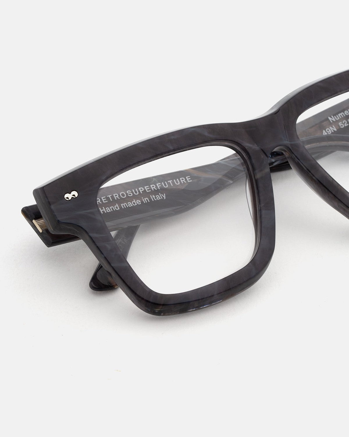 Close-up of the temple and hinge detail on RETROSUPERFUTURE Numero 116 Marmo Nero sunglasses.