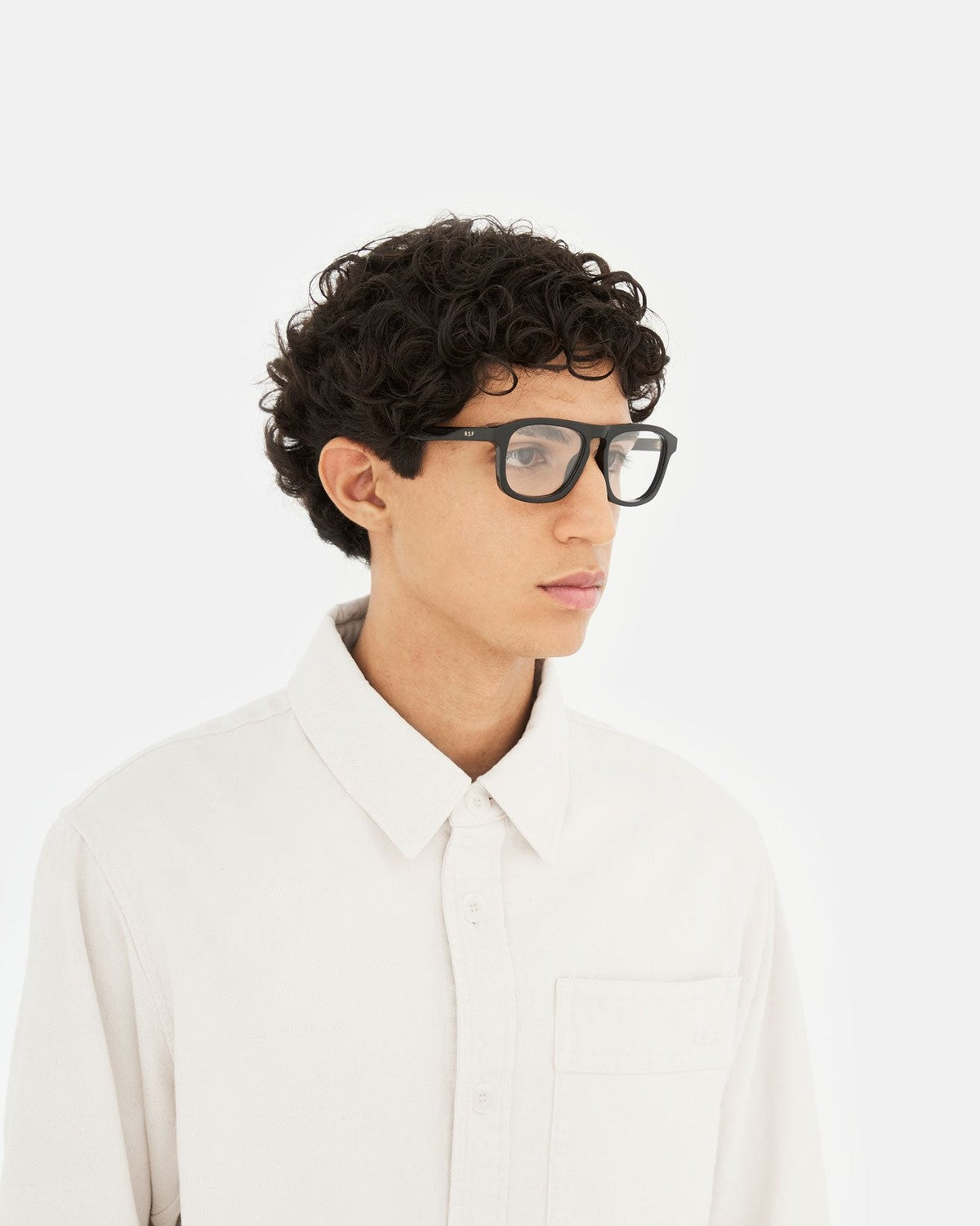 Side profile of model wearing RETROSUPERFUTURE Numero 123 Black sunglasses.