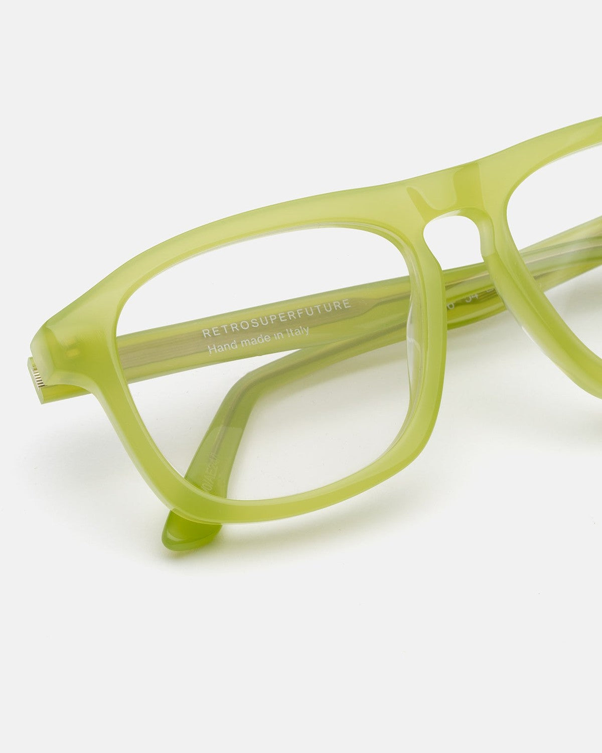 Close-up of the bridge and temple detailing on RETROSUPERFUTURE Numero 123 Lime sunglasses.