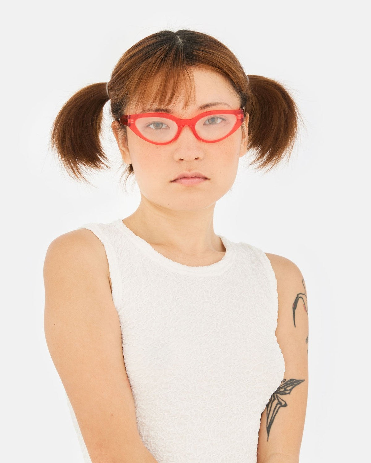 Front view of model wearing RETROSUPERFUTURE Numero 124 Light Red sunglasses.
