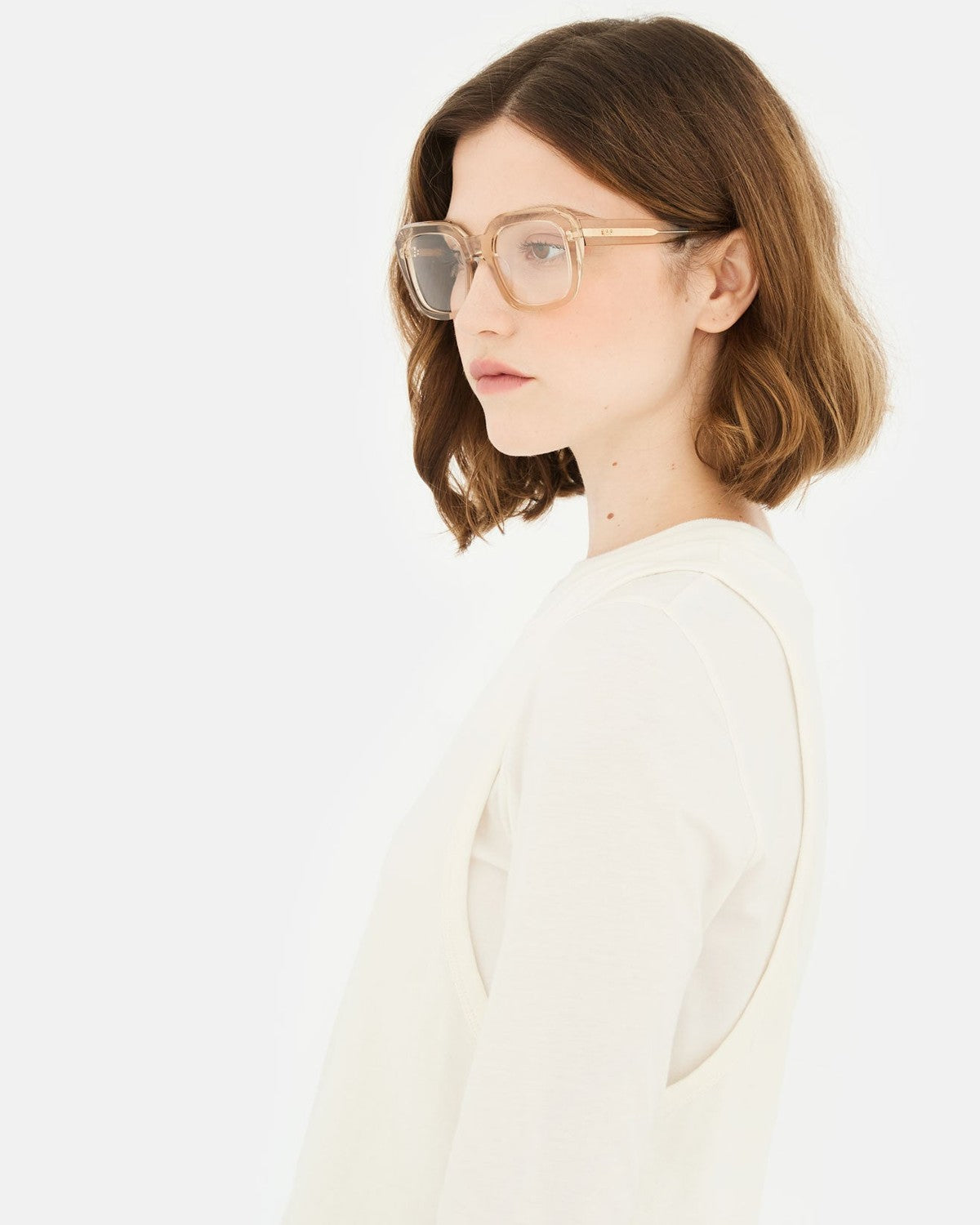 Side profile of model wearing RETROSUPERFUTURE Numero 125 Cream sunglasses.