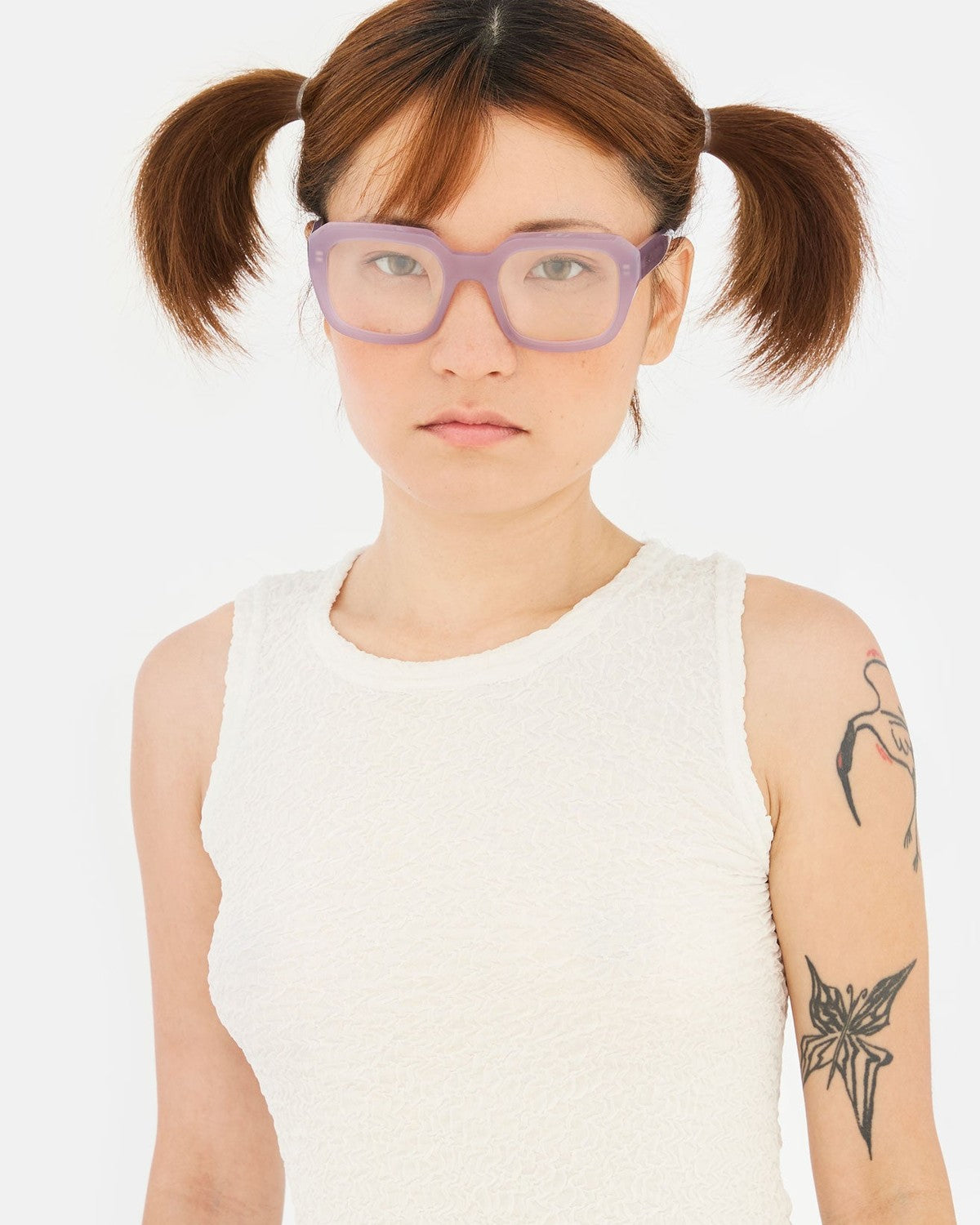 Model wearing RETROSUPERFUTURE Numero 125 Light Purple sunglasses in front view.