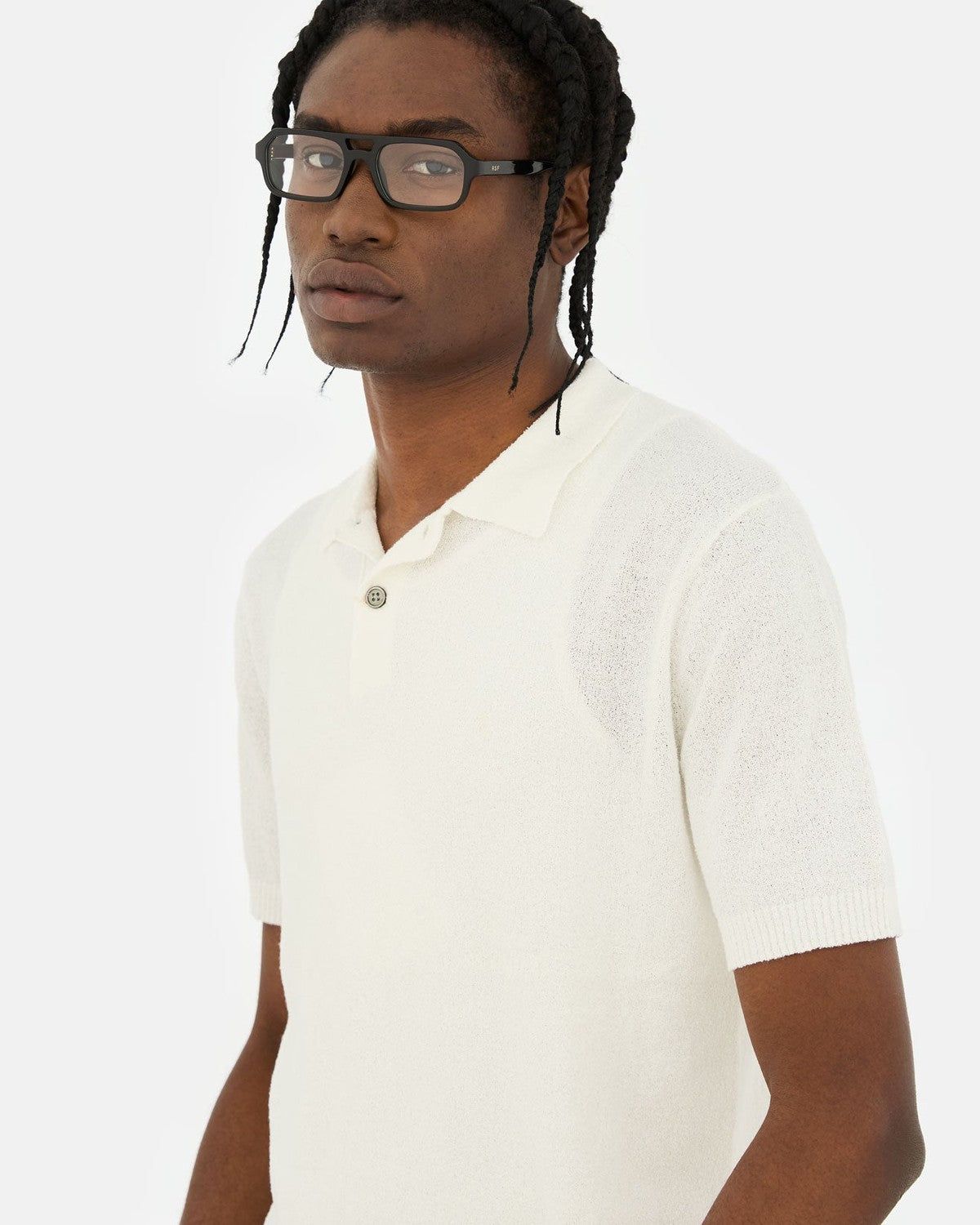 Model wearing RETROSUPERFUTURE Numero 128 Black sunglasses in profile.
