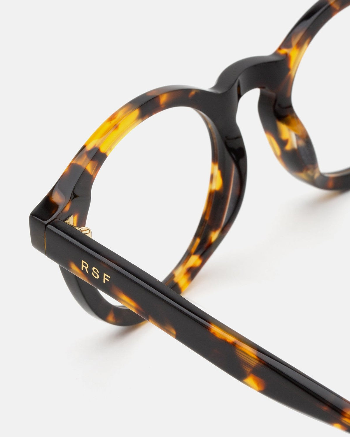 Close-up of the temple and frame detail on RETROSUPERFUTURE Numero 129 Burnt Havana sunglasses showing RSF branding.