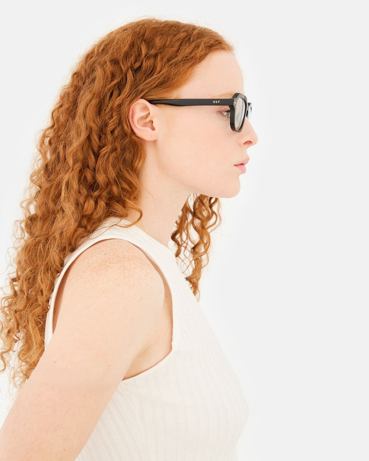 Side profile of model wearing RETROSUPERFUTURE Numero 130 Black sunglasses.