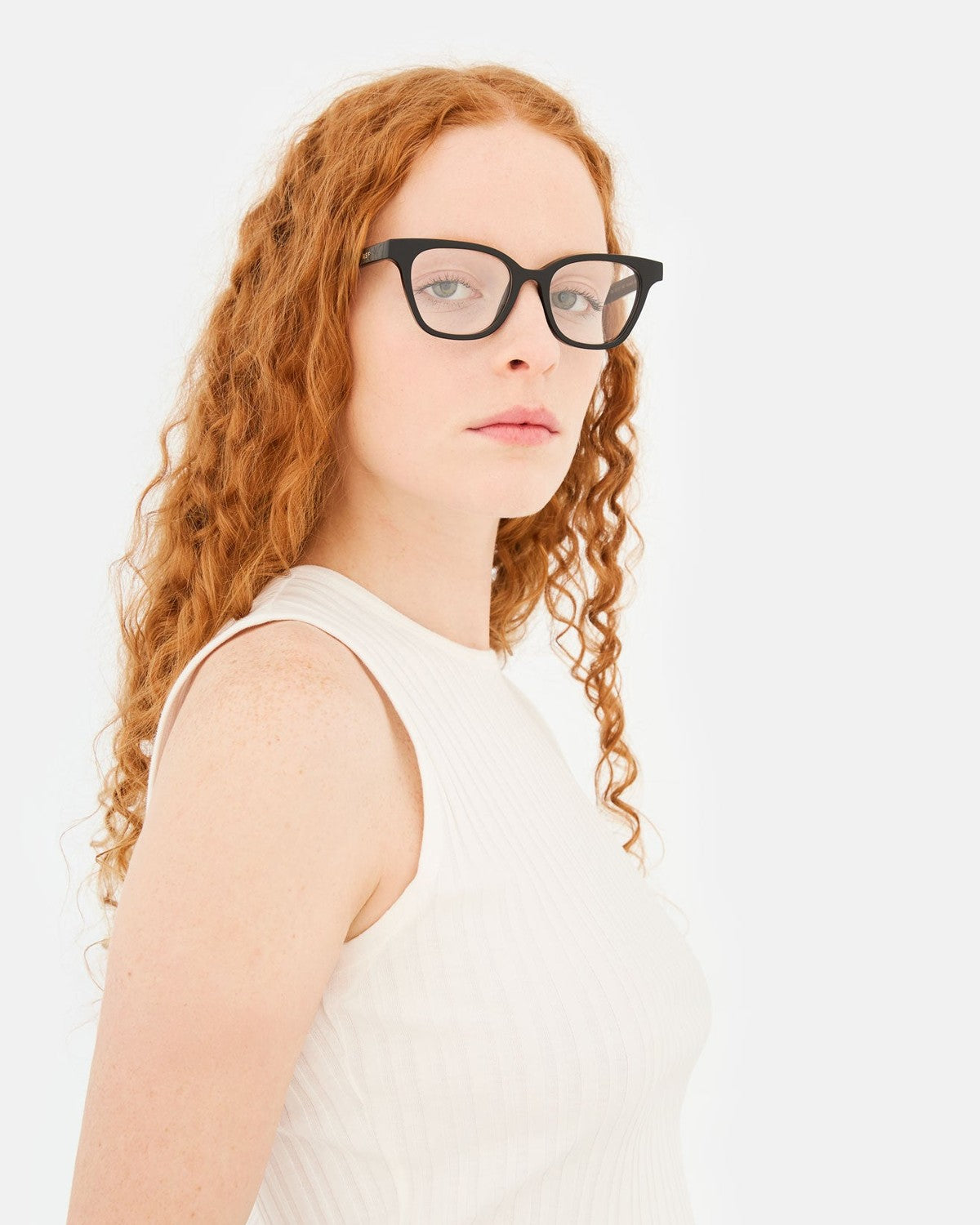 Model wearing RETROSUPERFUTURE Numero 131 Black sunglasses, side profile.