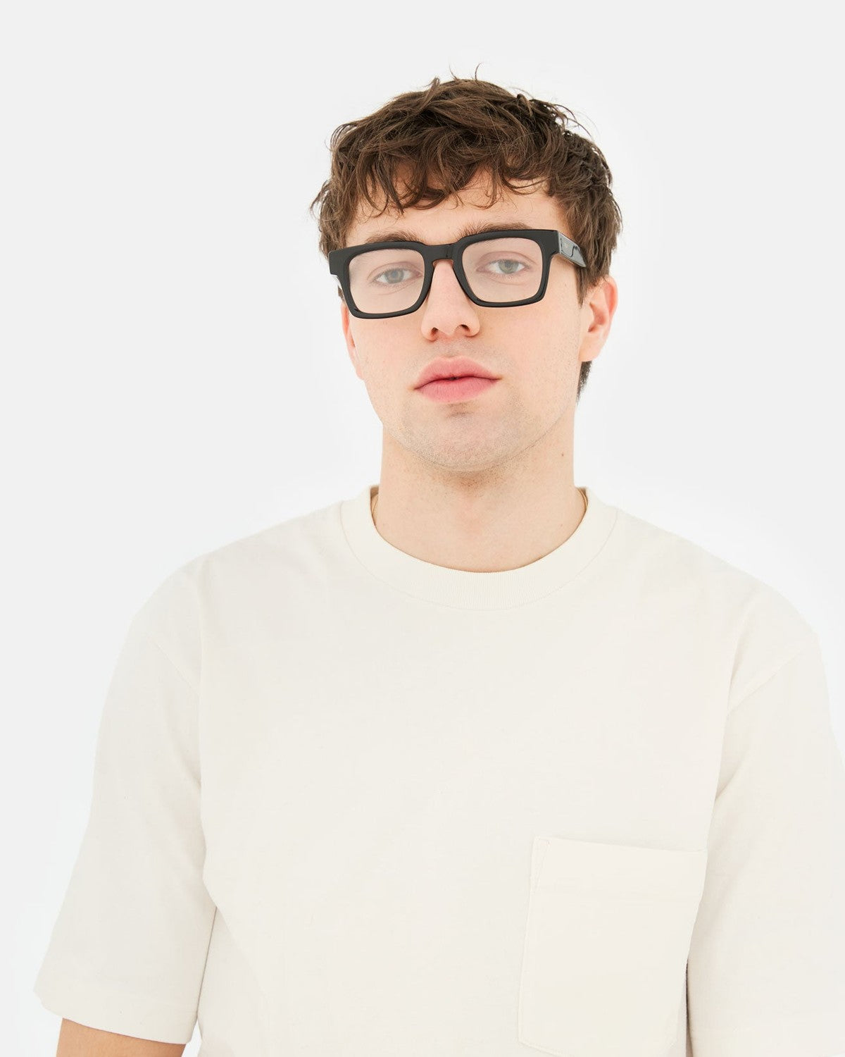 Model wearing RETROSUPERFUTURE Numero 133 Black sunglasses indoors.