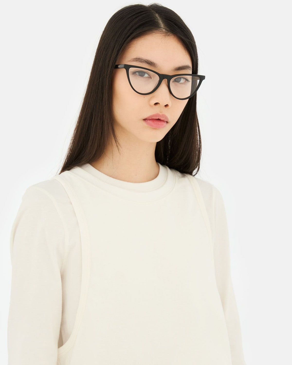 Model wearing RETROSUPERFUTURE Numero 135 Black sunglasses with a cream sweater.