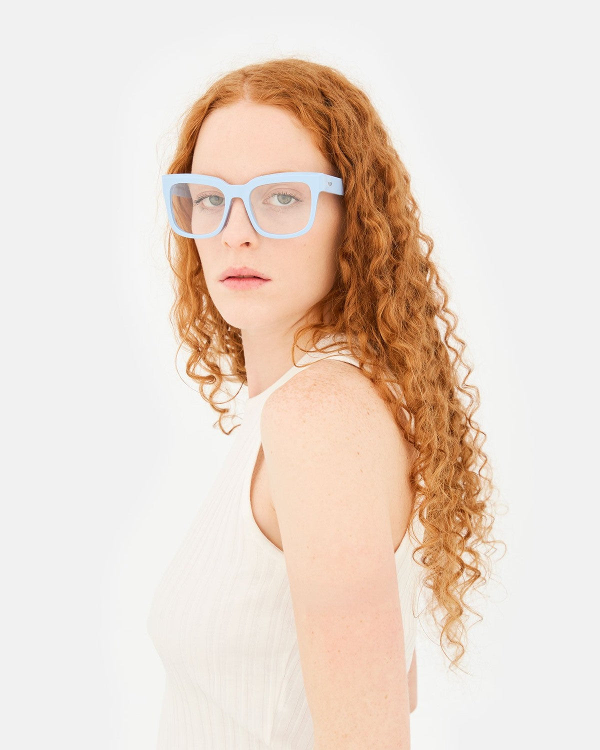 Model wearing RETROSUPERFUTURE Numero 136 Azzurro sunglasses, angled view.