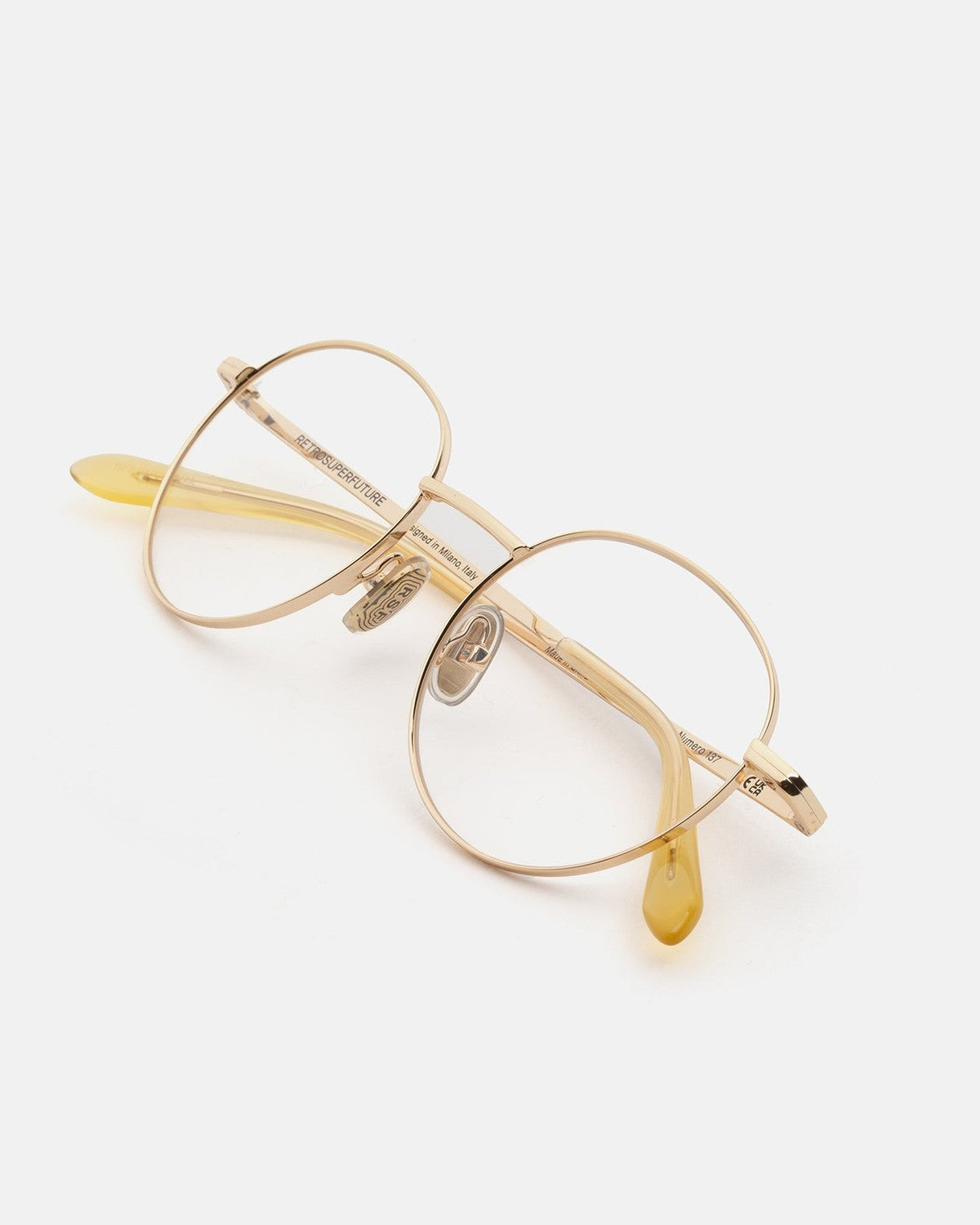 Overhead view of RETROSUPERFUTURE Numero 137 Cremoso sunglasses with folded temples.