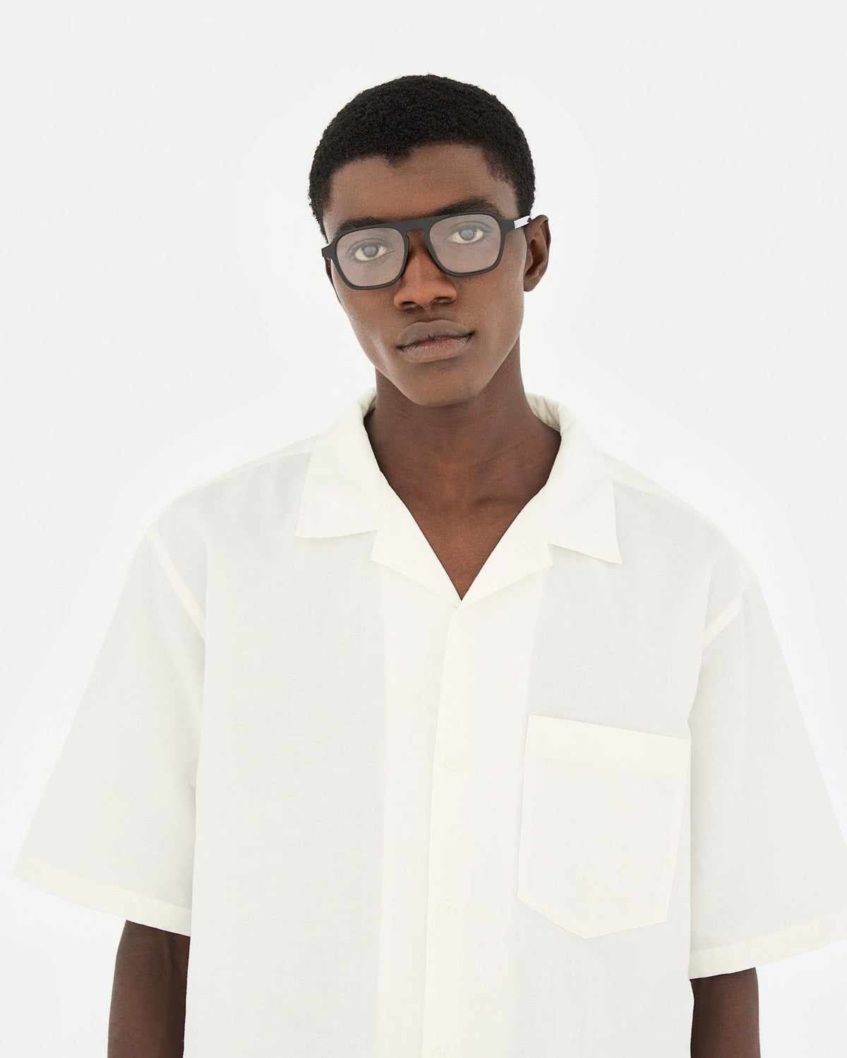 Model wearing RETROSUPERFUTURE Numero 142 Nero sunglasses with white shirt.