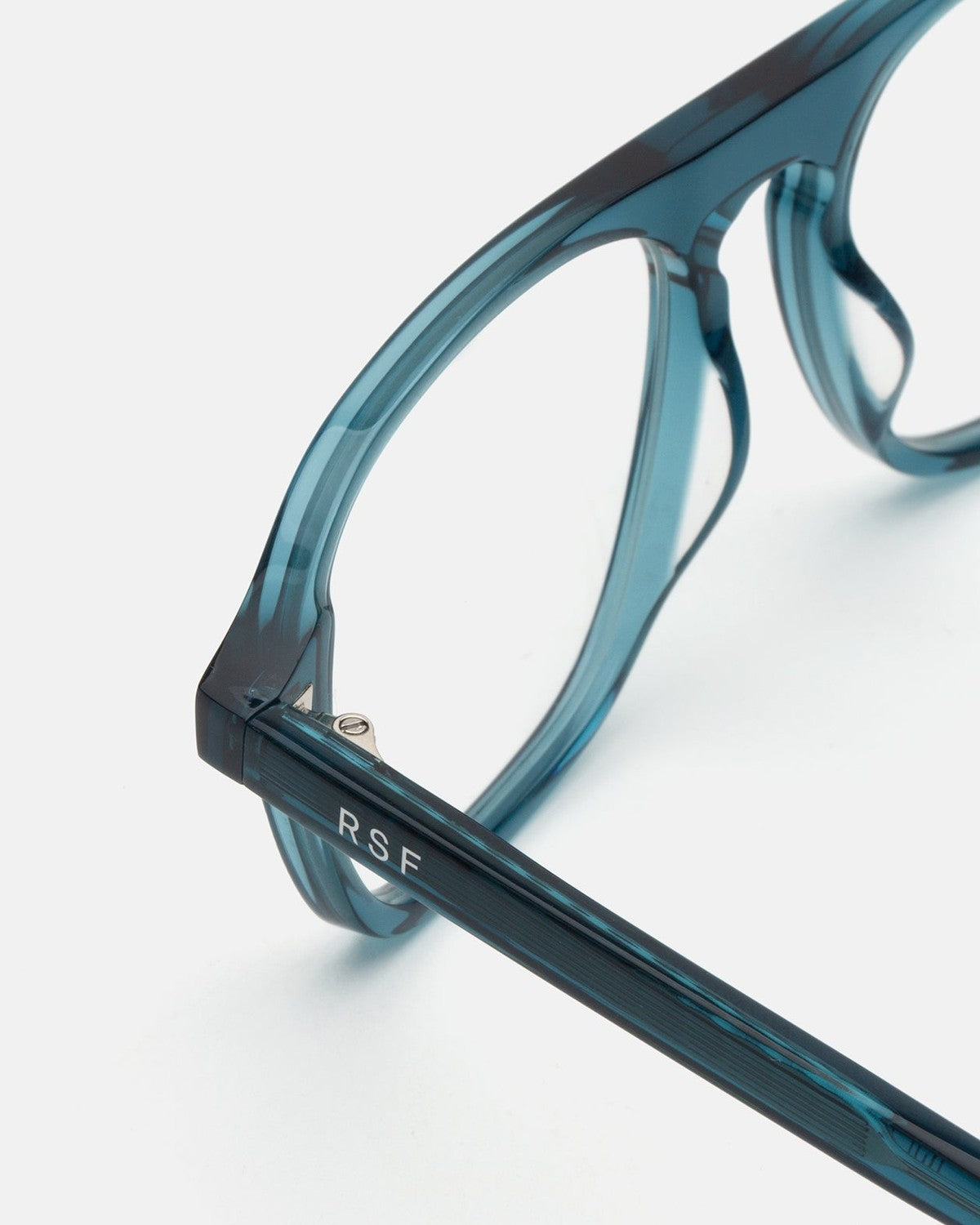 Close-up of the temple hinge and RSF branding on RETROSUPERFUTURE Numero 142 Teal sunglasses.
