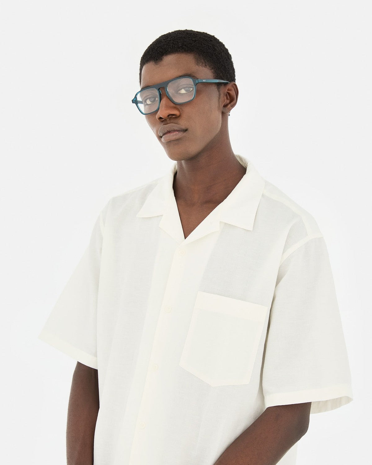 Model wearing RETROSUPERFUTURE Numero 142 Teal sunglasses in side profile.