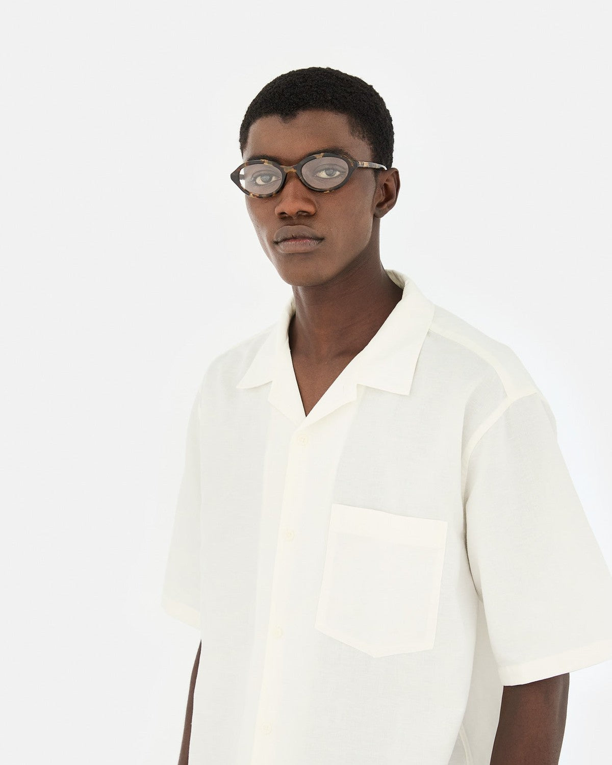 Model wearing RETROSUPERFUTURE Numero 145 Burnt sunglasses with white shirt, frontal pose.