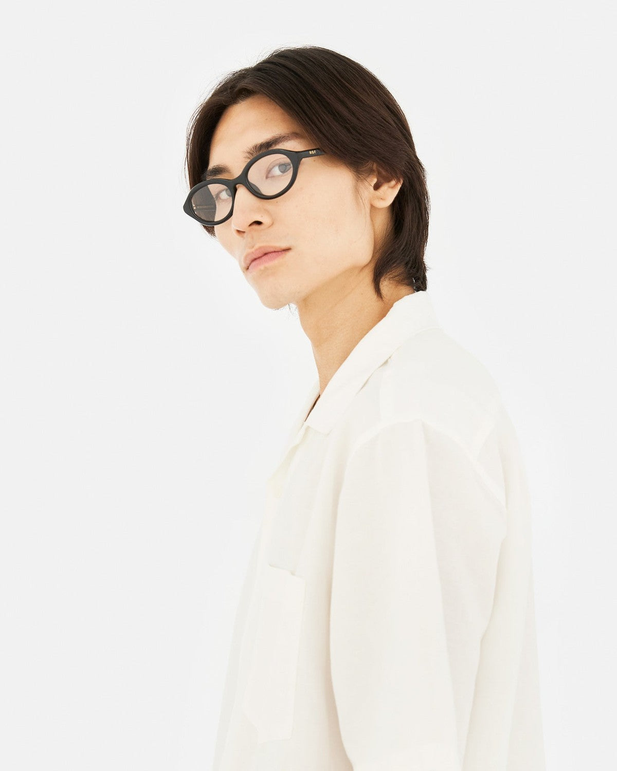 Model wearing RETROSUPERFUTURE Numero 145 Nero sunglasses in side profile.
