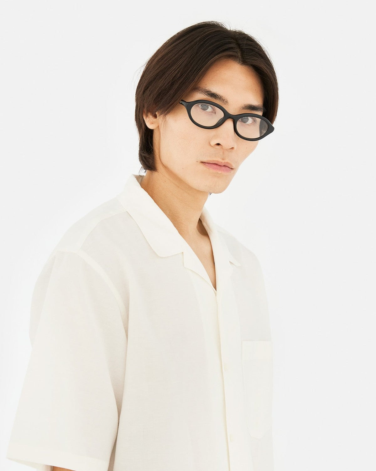 Model wearing RETROSUPERFUTURE Numero 145 Nero sunglasses in angled view.