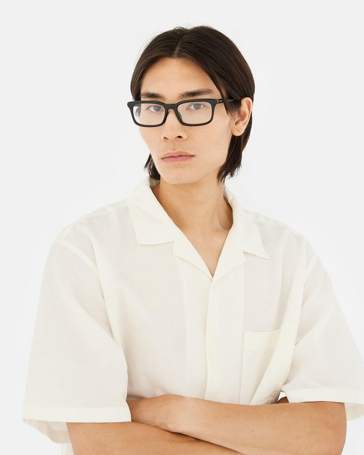 Model wearing RETROSUPERFUTURE Numero 146 Nero sunglasses with a white shirt.