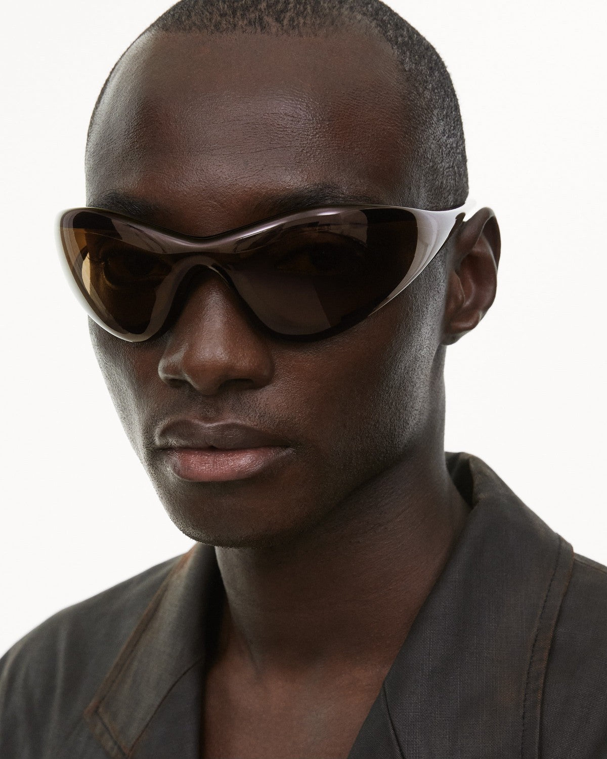Model wearing CHIMI One Brown Brown sunglasses, angled view.