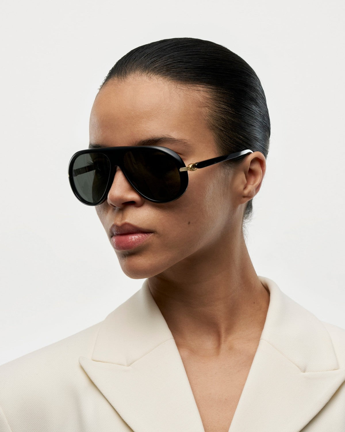 Side profile of model wearing CHIMI Oona Black sunglasses.