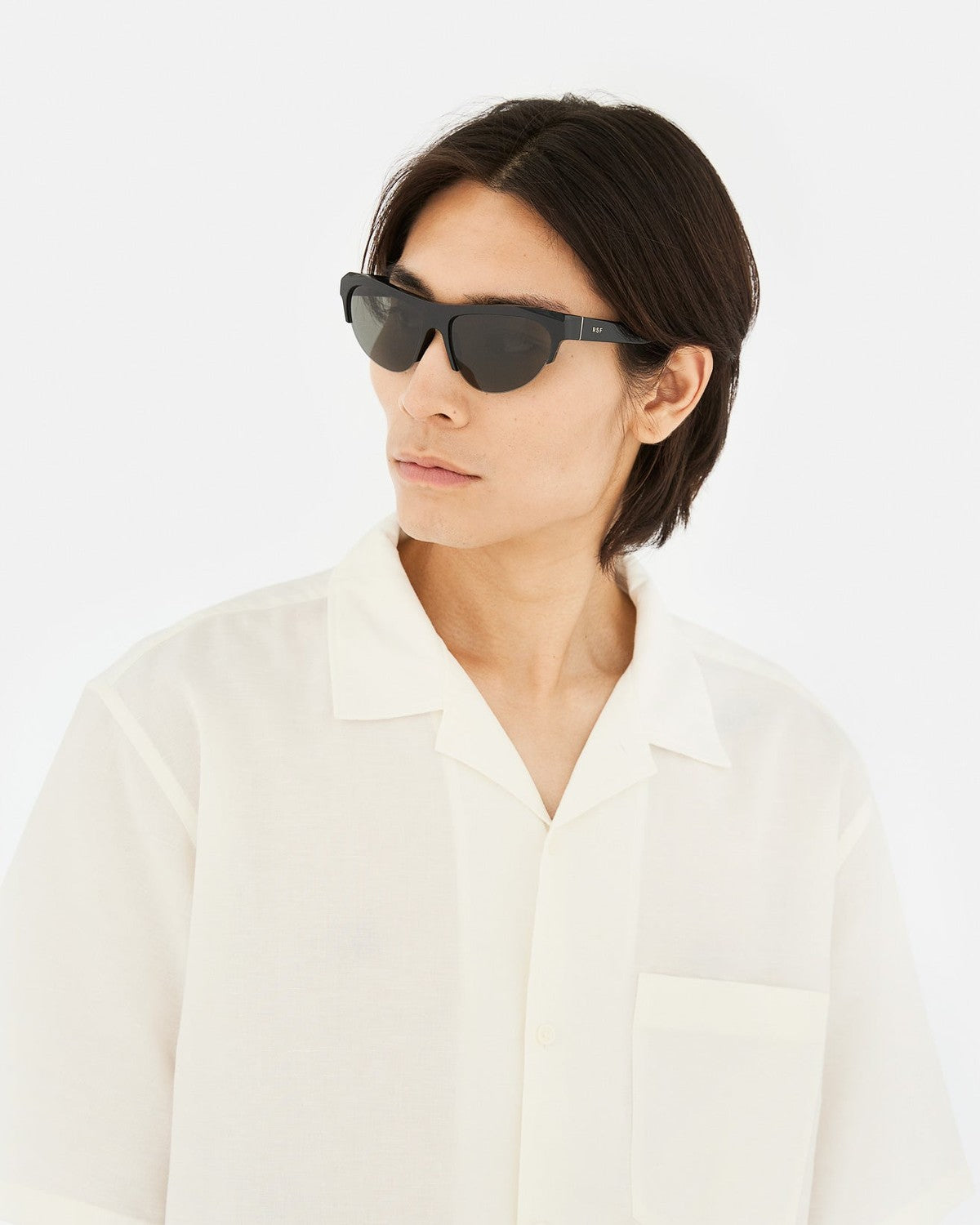 Model wearing RETROSUPERFUTURE Ora Black sunglasses with white shirt.