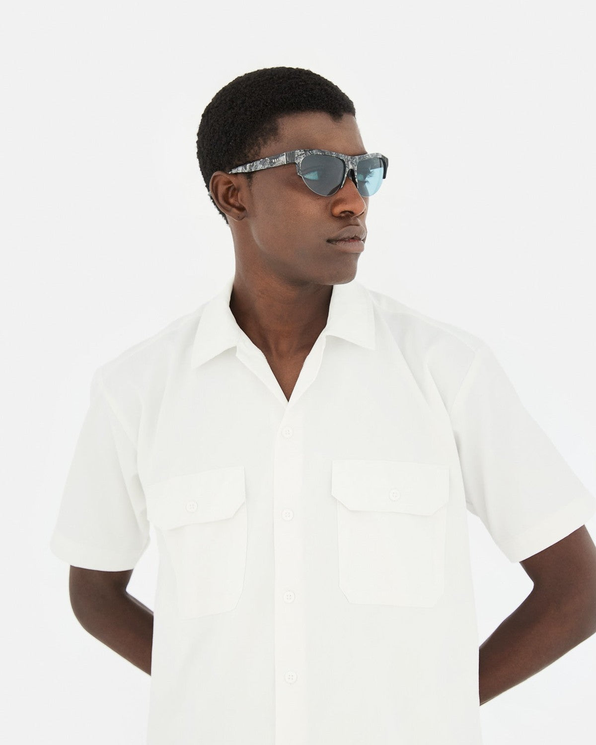 Side profile of model wearing RETROSUPERFUTURE Ora Granito sunglasses.