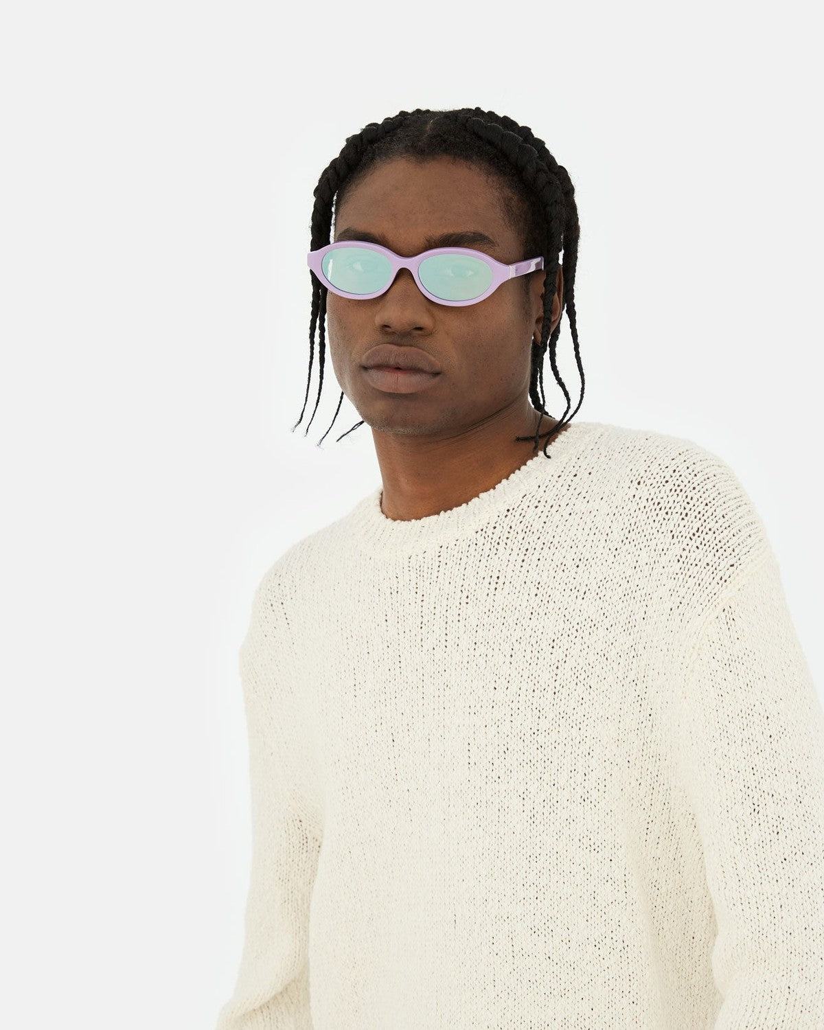 Model wearing RETROSUPERFUTURE Parola Caramella sunglasses with cream knit sweater.