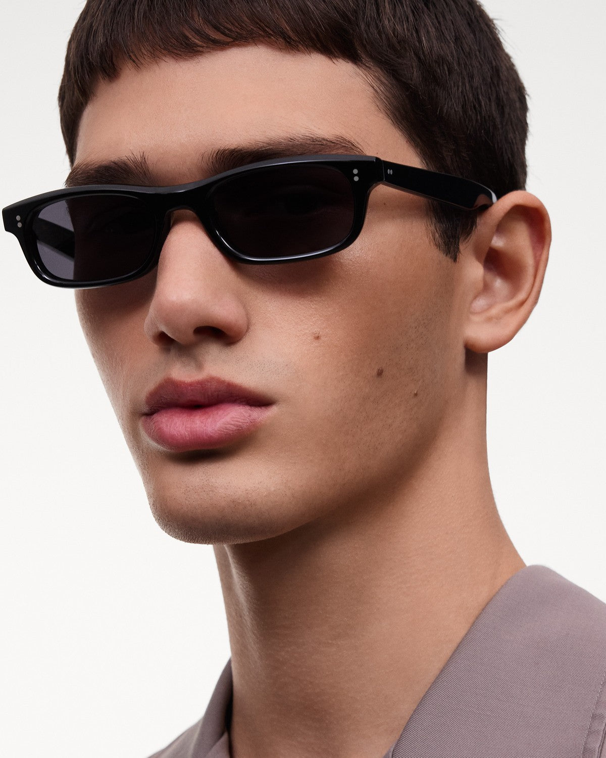 Model wearing CHIMI Pin Black Clear sunglasses in side profile.