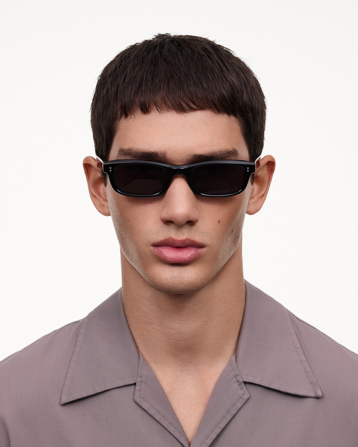 Model wearing CHIMI Pin Black Clear sunglasses in front view.