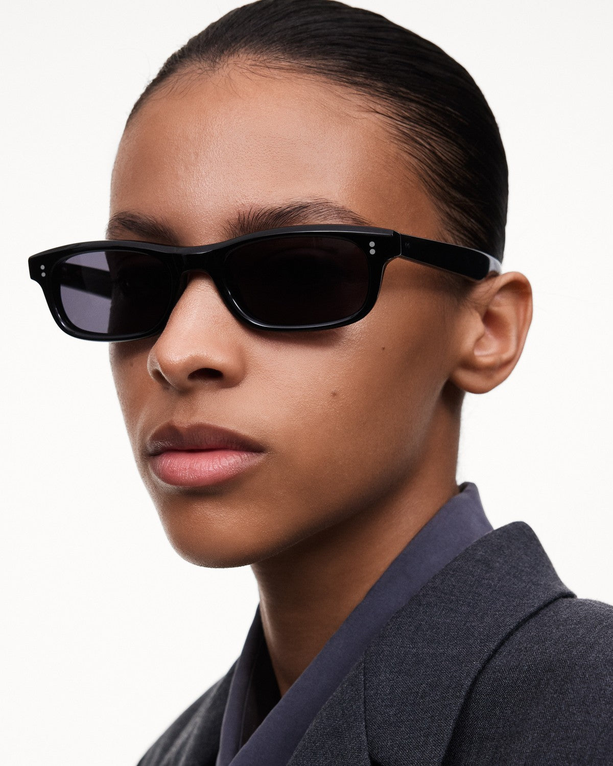 Model wearing CHIMI Pin Black Clear sunglasses at an angle.