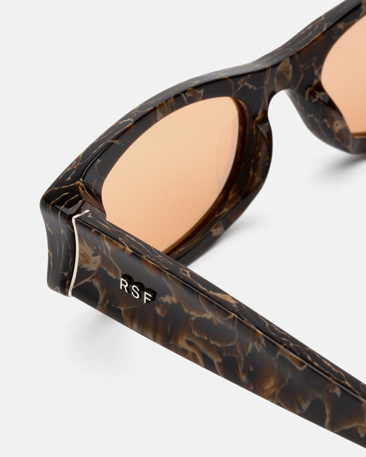 Close-up of the temple and hinge detail on RETROSUPERFUTURE Razzo Brown Marble sunglasses.