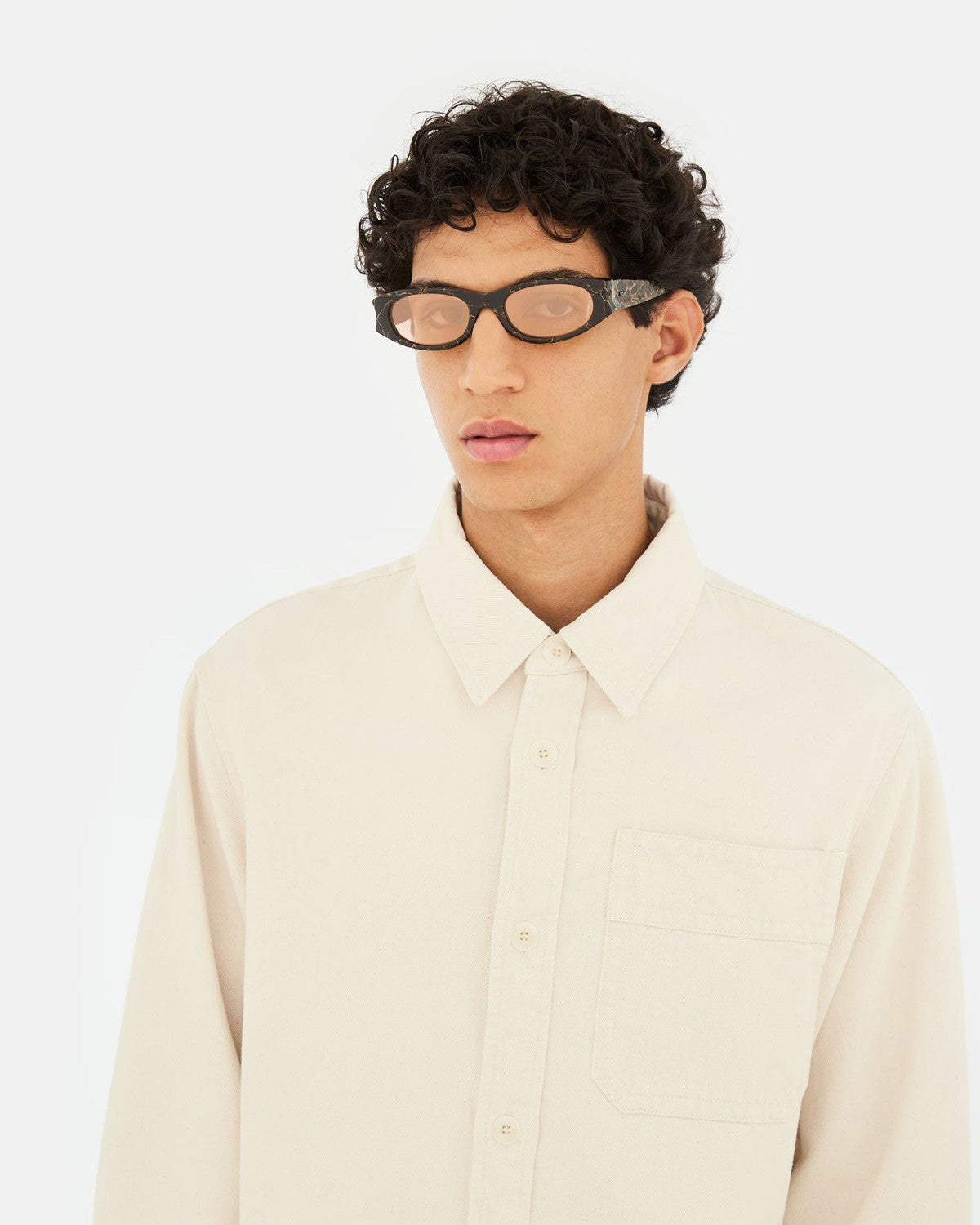 Model wearing RETROSUPERFUTURE Razzo Brown Marble sunglasses with a collared shirt.
