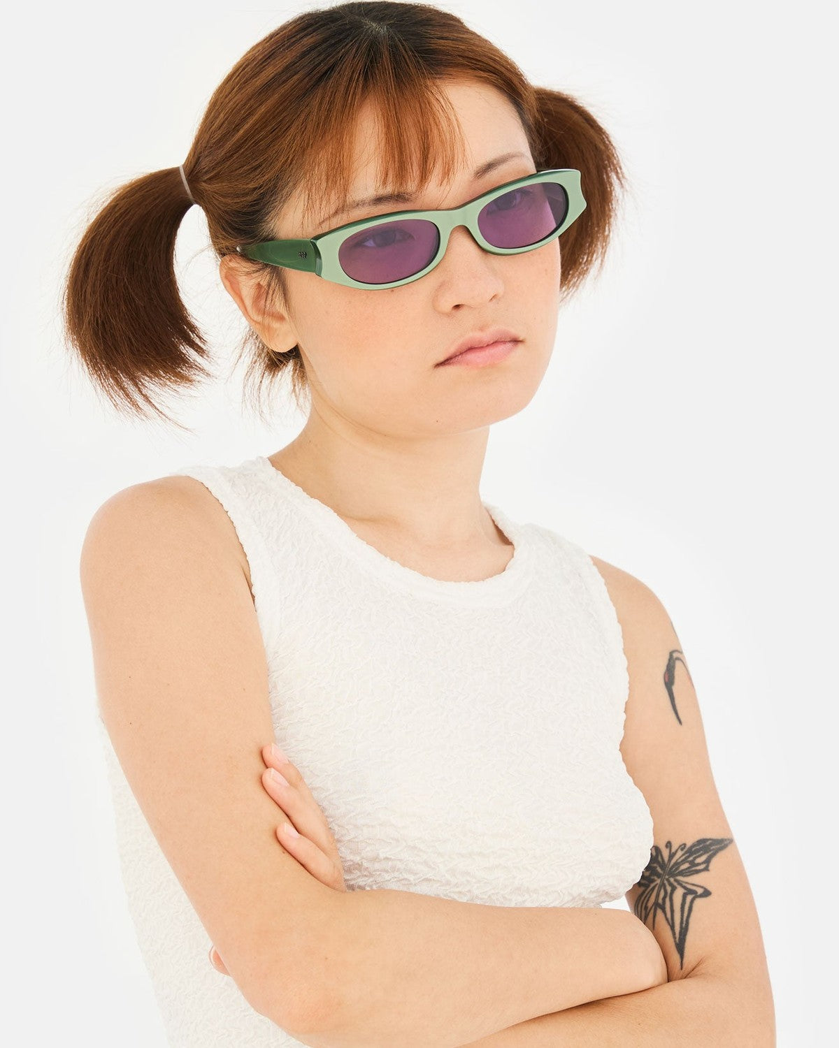 Model wearing RETROSUPERFUTURE Razzo Metallic Mint sunglasses.
