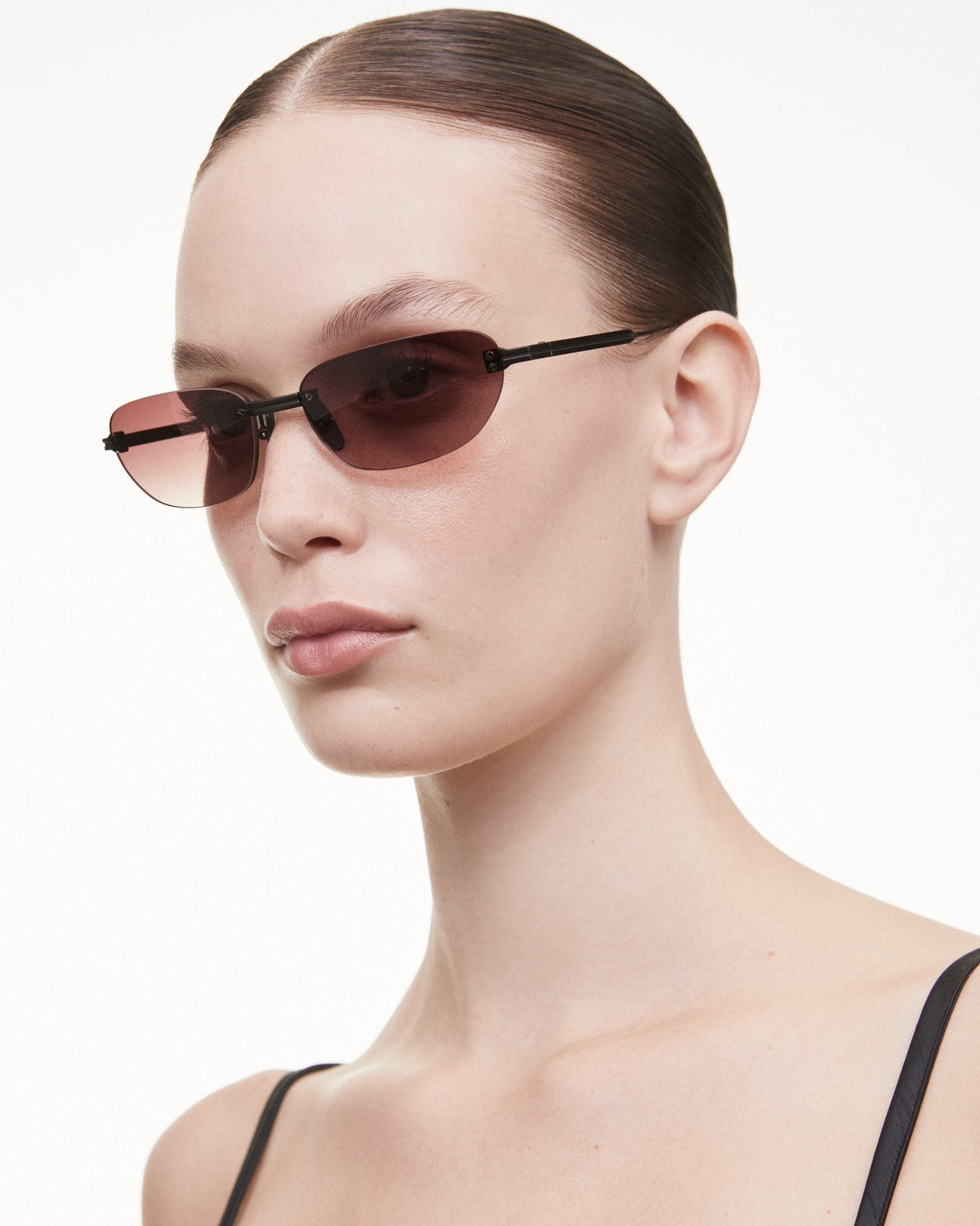 Model wearing CHIMI Rimless Oval Burgundy Gradient Red sunglasses, side profile.