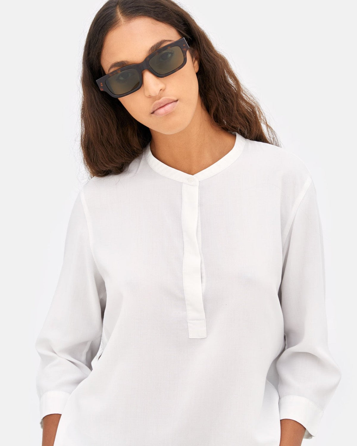 Model wearing RETROSUPERFUTURE Roma 3627 Green sunglasses with white shirt.