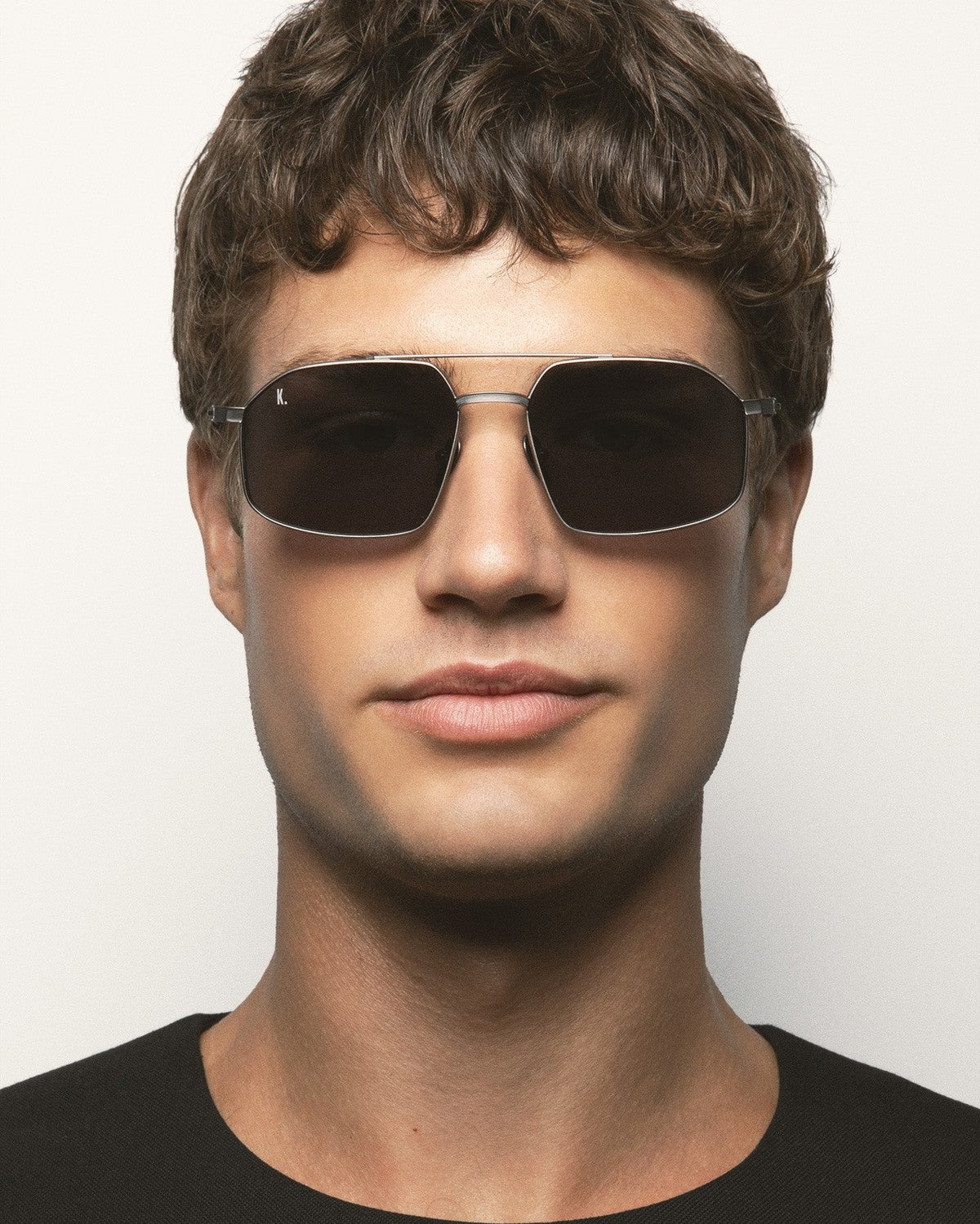 Model wearing KALEOS Ross Gun Matte Grey Mineral sunglasses.