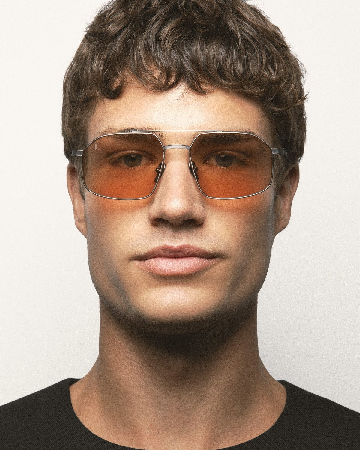 Model wearing KALEOS Ross Gun Matte Brown Photochromic sunglasses.