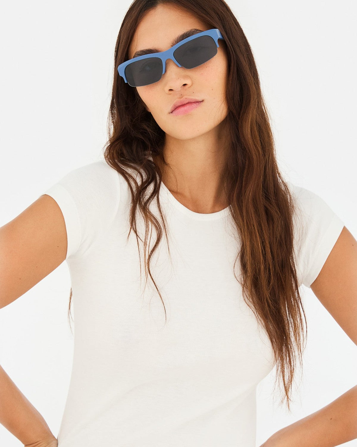 Model wearing RETROSUPERFUTURE Scatto Dusty Blue sunglasses with white top.