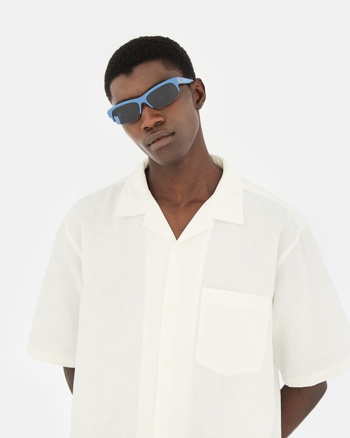 Model wearing RETROSUPERFUTURE Scatto Dusty Blue sunglasses with white shirt.