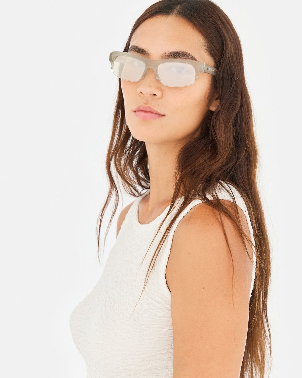 Model wearing RETROSUPERFUTURE Scatto Nebbia sunglasses with long hair and white textured top.