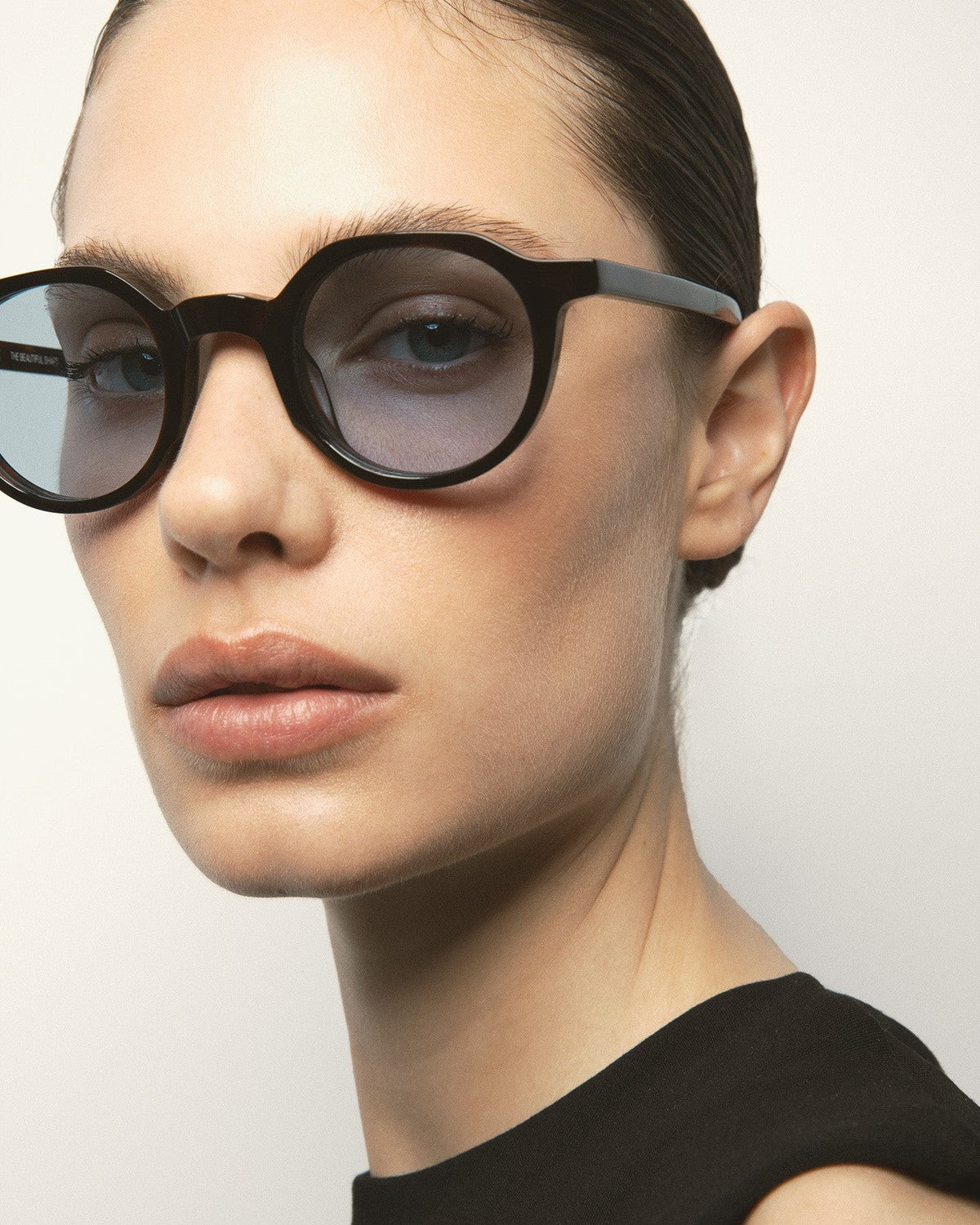 Model wearing KALEOS Scott Dark Havana Blue sunglasses, angled view.