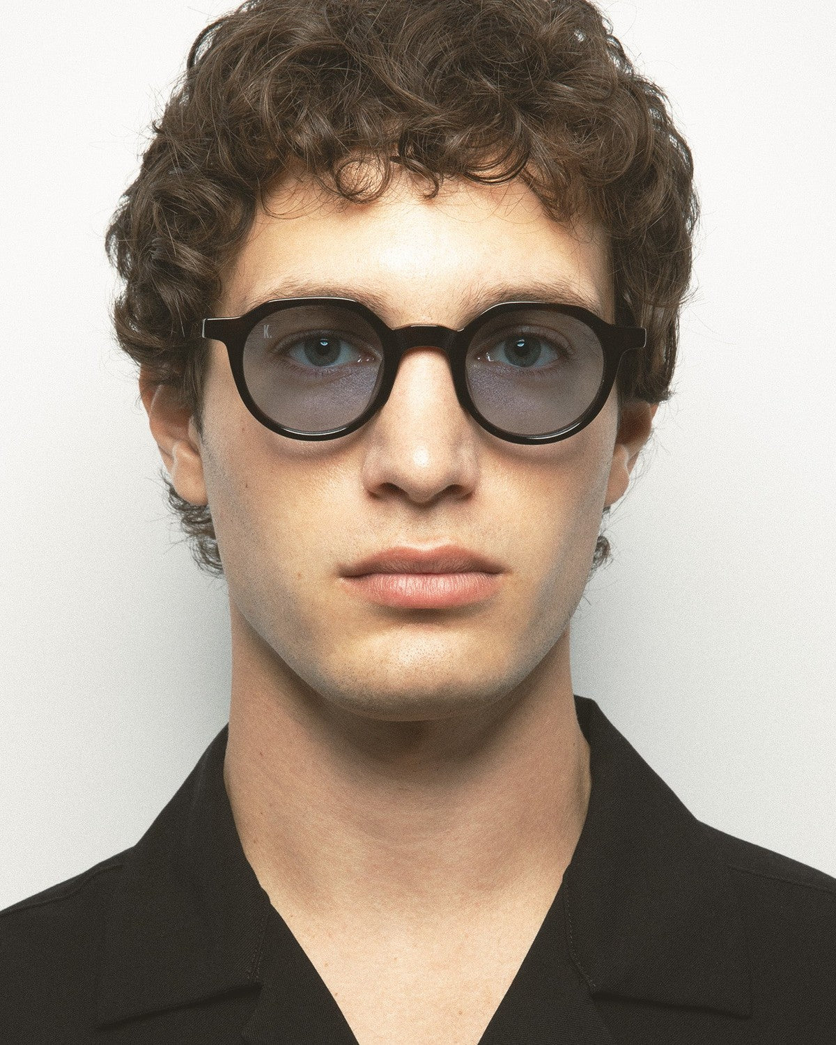 Model wearing KALEOS Scott Dark Havana Blue sunglasses, front view.