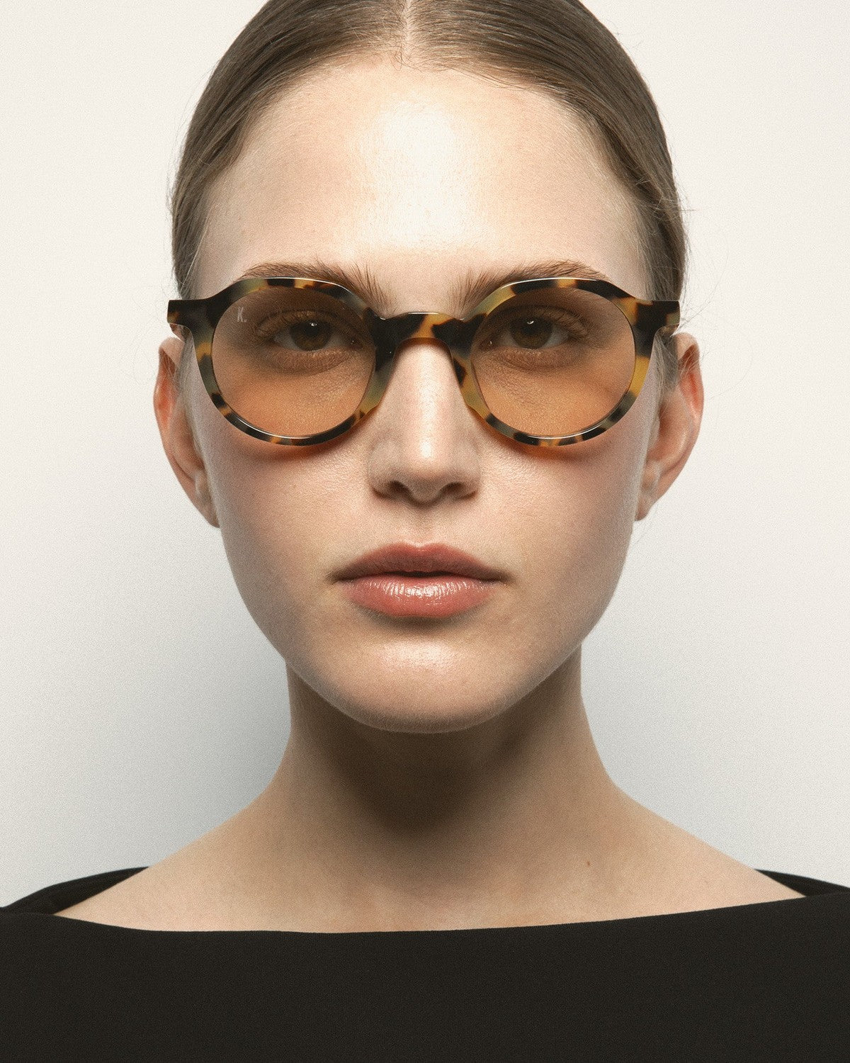 Model wearing KALEOS Scott Spotted Havana Brown Photochromic sunglasses, front view.
