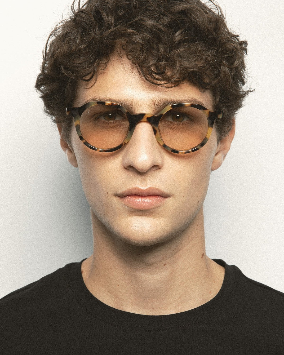 Model wearing KALEOS Scott Spotted Havana Brown Photochromic sunglasses, front view.