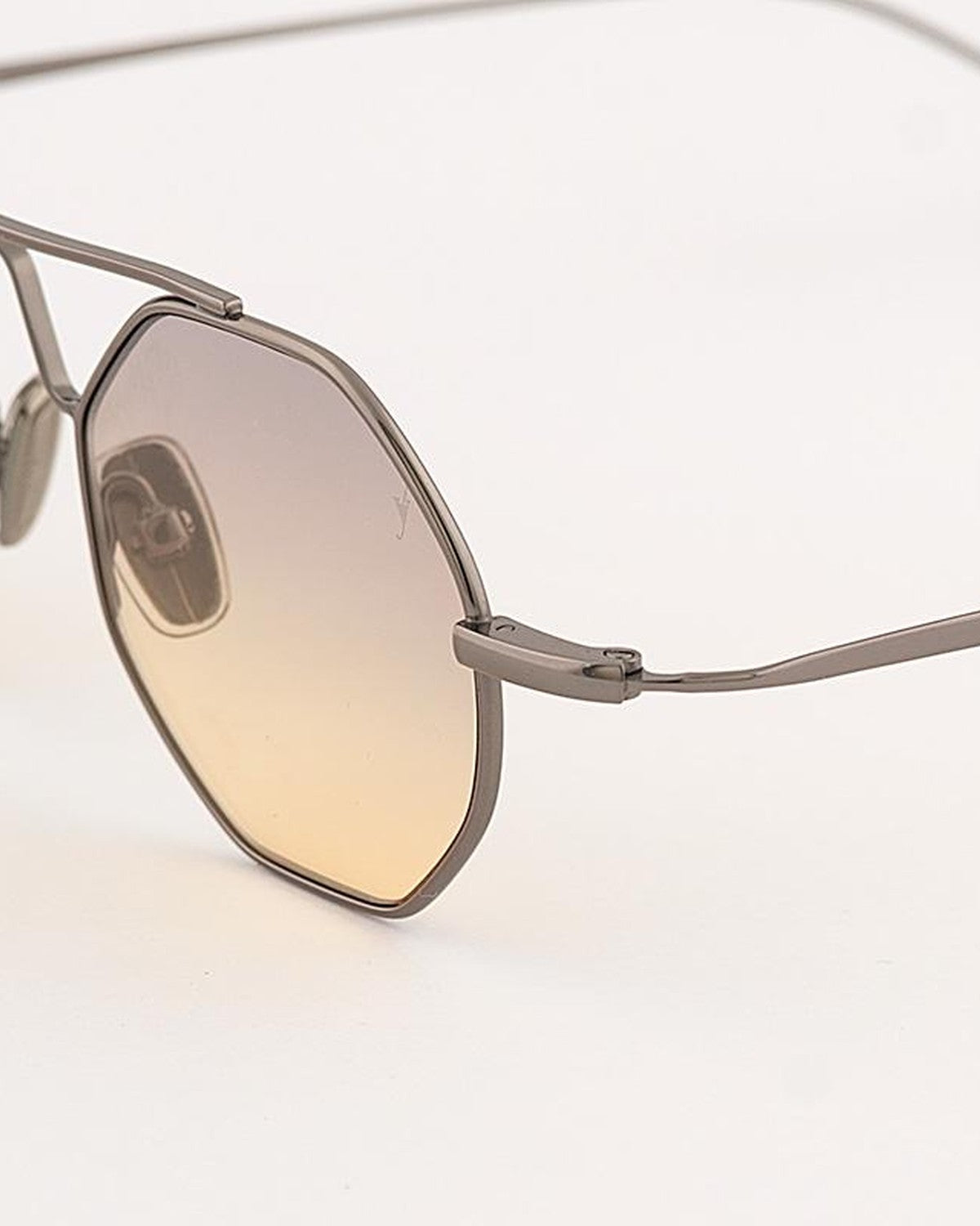 Close-up of the octagonal lens and metal bridge detail on EYEPETIZER SOHO C.3-19 sunglasses.